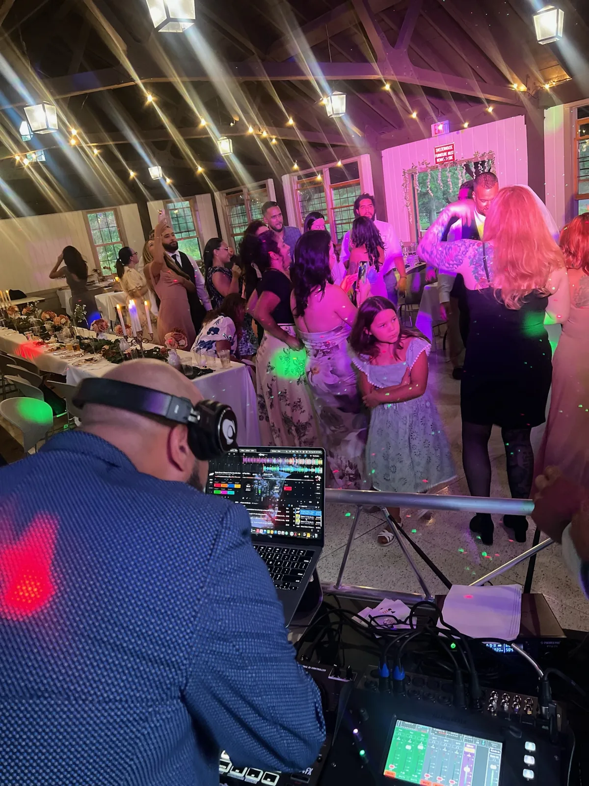 DJ mixing music in front of party guests