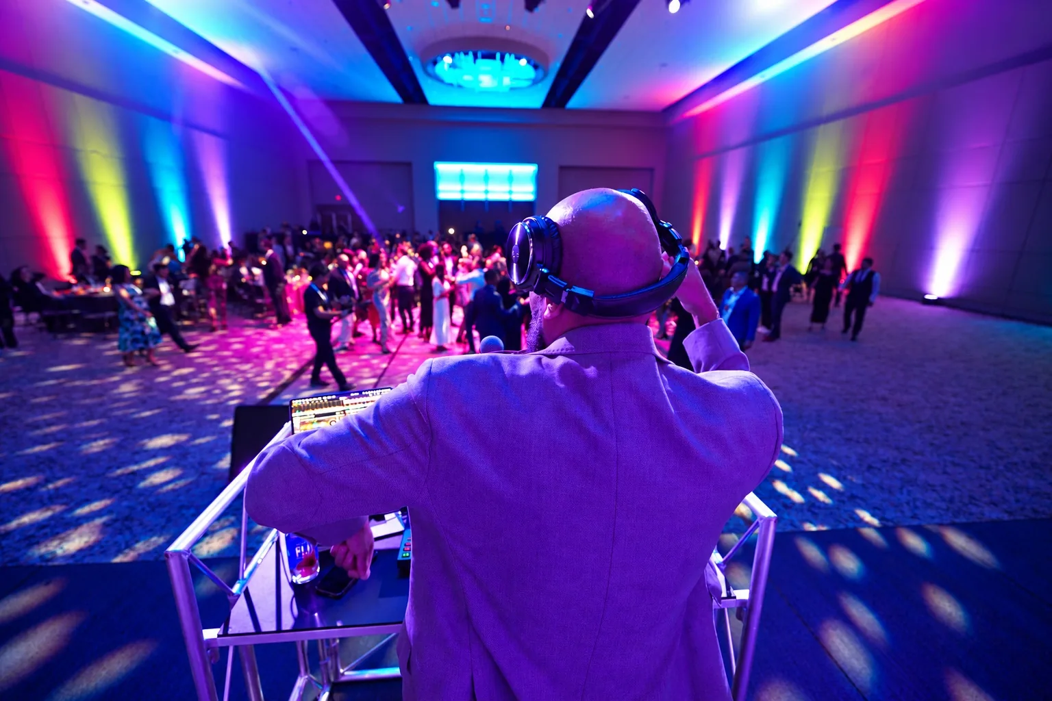 DJ facing a crowd at a large event
